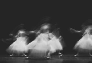 a group of dancers in motion on a stage